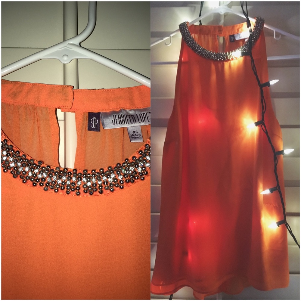 J. Lo bright orange blouse/tank top.